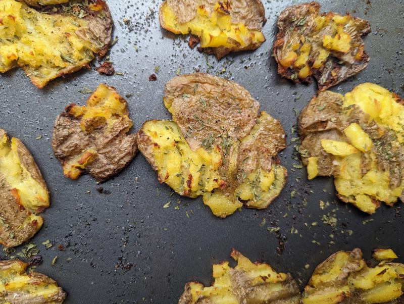 Smashed potatoes on a baking sheet